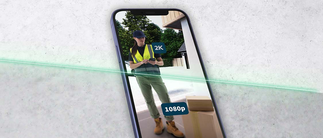 Mobile phone view in 2K video at 1080p of a delivery woman with large boxes at the doorstep.